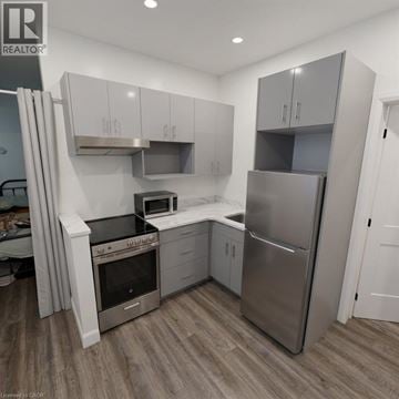 Stratford apartment for rent - A modern kitchen with stainless steel appliances and white cabinets.