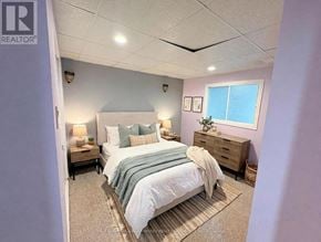 Ajax (South East) apartment for rent - A bedroom with a bed, nightstand, and lamp.