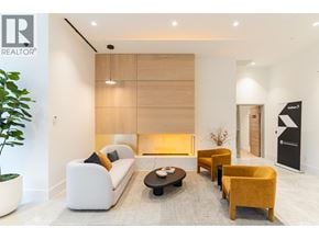 Burnaby apartment for rent - A modern living room with a white sofa, yellow armchair, and a coffee table.