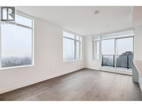 Burnaby apartment for rent - A large empty room with a view of the city.