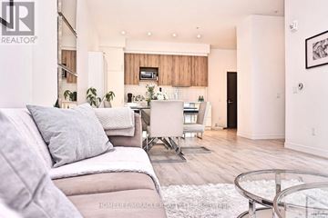 Waterloo condo for rent - A living room with a grey couch and a glass coffee table.