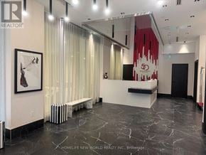Toronto (Church-Yonge Corridor) condo for rent - A realtor office with a white reception desk and a red and white logo on the wall.