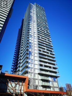 Toronto (Church-Yonge Corridor) condo for rent - A tall building with many windows and balconies is under construction.