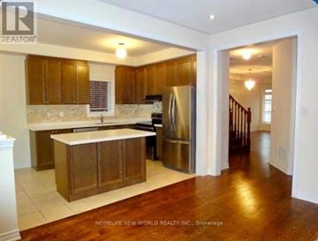 Richmond Hill (Oak Ridges) apartment for rent - A kitchen with wooden cabinets and a refrigerator.