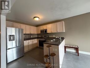 London South (South T) apartment for rent - A kitchen with a refrigerator, microwave, oven, and sink.