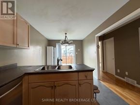 London South (South T) apartment for rent - A kitchen with wooden cabinets and a black countertop.