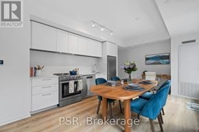 Toronto (Mount Pleasant West) condo for rent - A modern kitchen with a dining table set for two.