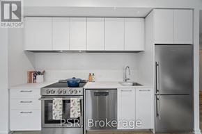 Toronto (Mount Pleasant West) condo for rent - A modern kitchen with white cabinets and stainless steel appliances.