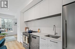Toronto (Mount Pleasant West) condo for rent - A modern kitchen with stainless steel appliances and white cabinets.