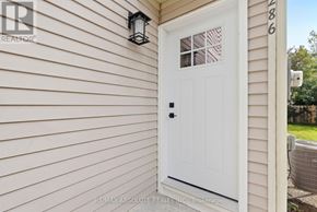 Ottawa apartment for rent - A white door with a black handle and a black lantern on the wall above it.