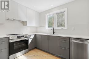 Ottawa apartment for rent - A modern kitchen with stainless steel appliances and white cabinets.