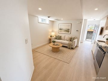 Edmonton apartment for rent - A living room with a couch, a coffee table, and a painting on the wall.