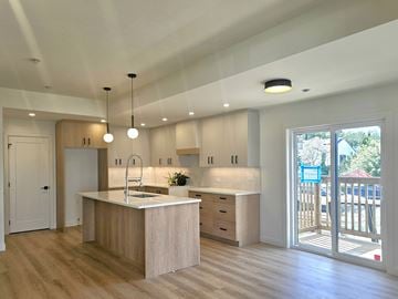 Edmonton apartment for rent - A modern kitchen with wooden cabinets and a white countertop.