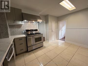 Mississauga (Lakeview) apartment for rent - A kitchen with a stove top oven and a range hood.