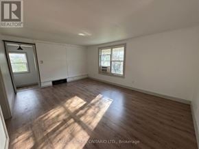 New Tecumseth (Beeton) duplex for rent - A room with wooden flooring and white walls, with a window on the right side.