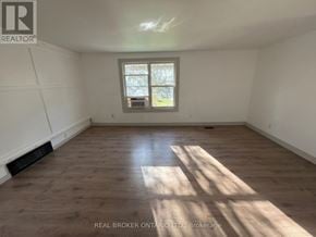 New Tecumseth (Beeton) duplex for rent - A room with wooden flooring and a window letting in sunlight.