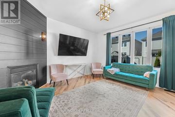 Ottawa apartment for rent - A living room with a green couch and a fireplace.