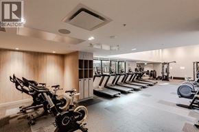 Richmond apartment for rent - A gym with a row of stationary bikes and a row of treadmills.
