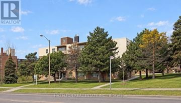 Toronto (Parkwoods-Donalda) condo for rent - A building with a sign that says Hazelton Real Estate Inc. Brokerage.