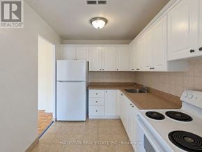 Toronto (Parkwoods-Donalda) condo for rent - A kitchen with white appliances and cabinets.