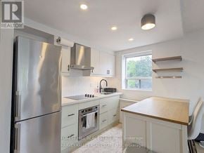Toronto (Woodbine Corridor) condo for rent - A kitchen with a refrigerator, oven, and sink.