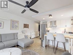 Toronto (Woodbine Corridor) condo for rent - A real estate listing photo of a modern kitchen and living room.