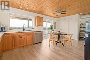 Walford apartment for rent - A kitchen with wooden cabinets and a table with chairs.