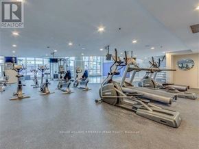 Toronto (Moss Park) condo for rent - A gym with a row of treadmills and elliptical machines.