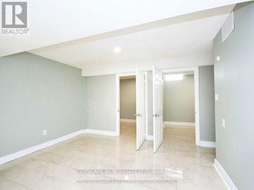 Mississauga (Meadowvale) apartment for rent - A spacious room with a doorway leading to another room.