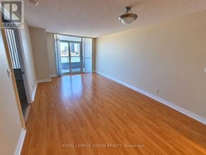 Markham (Unionville) condo for rent - A room with wooden flooring and a sliding glass door.