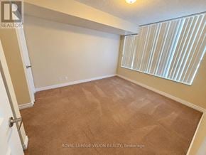 Markham (Unionville) condo for rent - A room with a carpeted floor and a window with blinds.