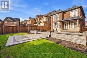 Oakville (Go Glenorchy) apartment for rent - A sunny day in a suburban neighborhood with a house and a yard.