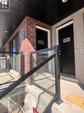 St. Catharines (E. Chester) townhouse for rent - A black metal railing is in front of a glass door.