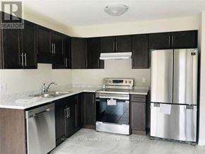 Niagara Falls (Oldfield) townhouse for rent - A kitchen with black cabinets and stainless steel appliances.