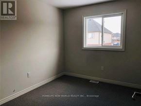 Niagara Falls (Oldfield) townhouse for rent - A room with a window showing a view of a house and a car.