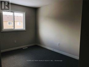 Niagara Falls (Oldfield) townhouse for rent - A room with a window and a carpeted floor.