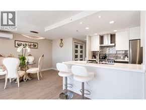 Vancouver apartment for rent - A modern kitchen with white chairs and a bar stools.