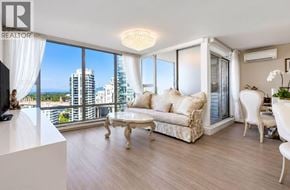 Vancouver apartment for rent - A living room with a large window overlooking a cityscape.