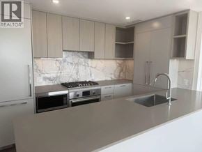 Burnaby apartment for rent - A modern kitchen with a marble backsplash and stainless steel appliances.