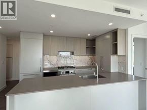 Burnaby apartment for rent - A modern kitchen with a marble backsplash and stainless steel appliances.