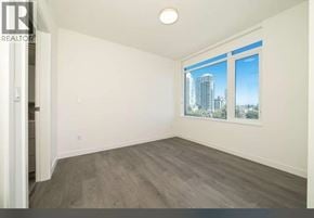 Burnaby apartment for rent - A spacious room with a view of the city through the window.