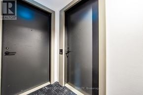 Toronto (Waterfront Communities) condo for rent - A brokerage realtor sign is on the bottom of a hallway.