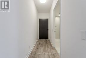 Toronto (Waterfront Communities) condo for rent - A hallway with a black door and white walls.