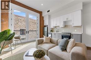 Hamilton apartment for rent - A living room with a couch, a table, and a plant.