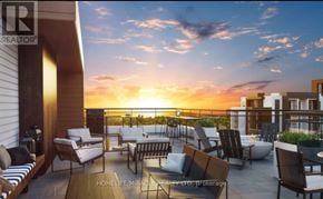 Milton (Walker) condo for rent - A sunset view from a rooftop patio with chairs and a table.