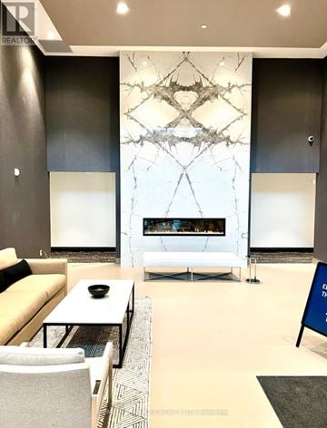 Milton (Walker) condo for rent - A modern living room with a white sofa and a fireplace.