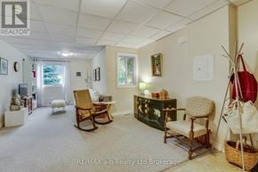 Woodstock (Woodstock - North) multi-family for rent - A living room with a carpeted floor and a white ceiling.