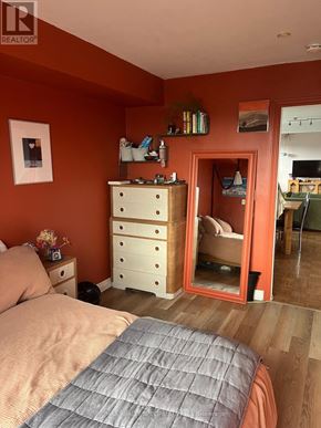 Toronto (Palmerston-Little Italy) multi-family for rent - A room with wooden flooring and two windows, one of which has blinds.