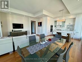 Toronto (Annex) condo for rent - A modern kitchen with a glass table and chairs.