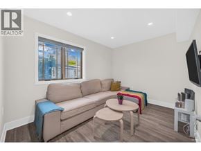 Bc apartment for rent - A living room with a couch, a table, and a television.